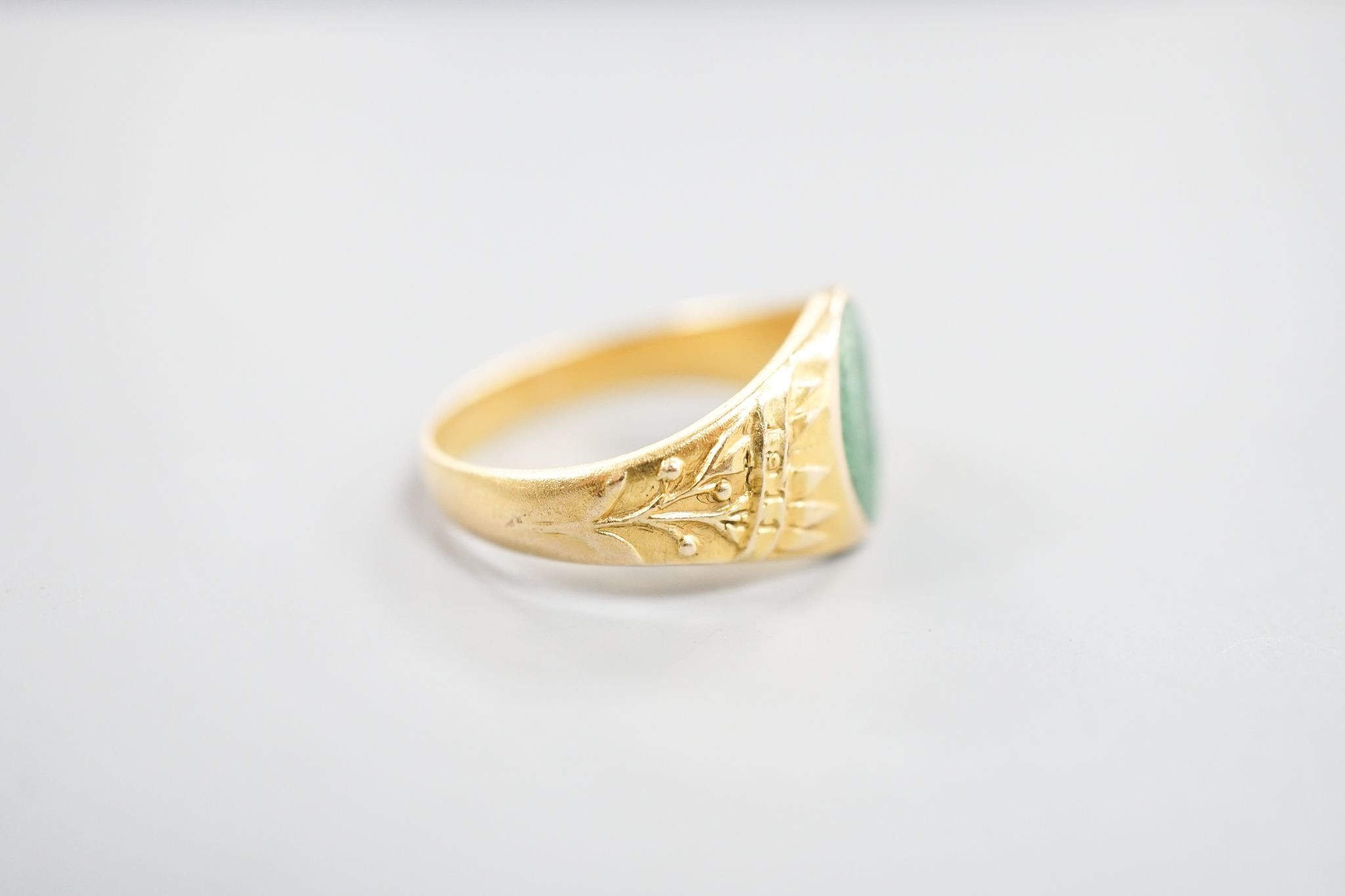 An early 20th century Austro-Hungarian (Vienna) 580/1000 yellow metal and green enamel signet ring, depicting the bust of a gentleman to sinister, size Q/R, gross 6.7 grams.